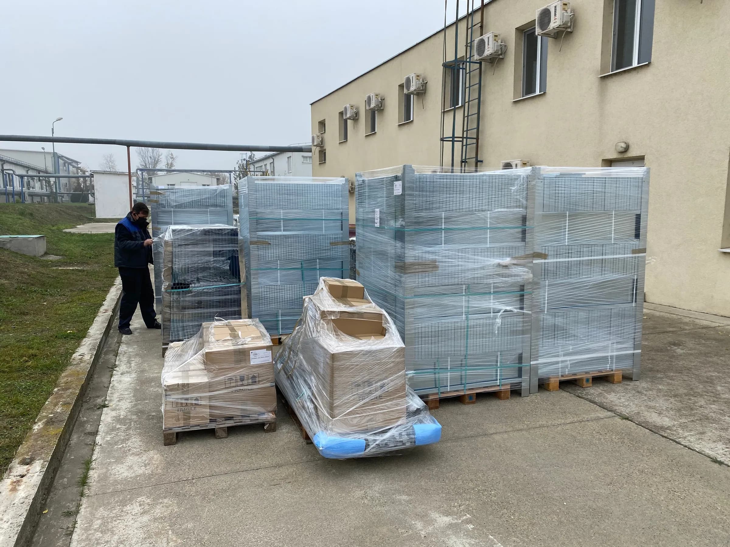 Rafturile ambalate pe paleți, la livrare, în curtea clădirii